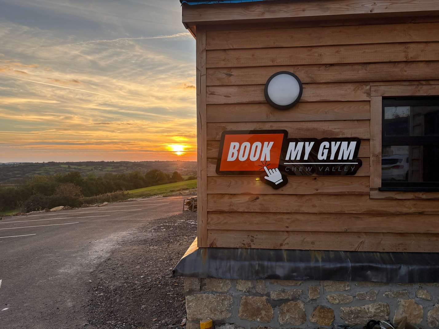 Book My Gym exterior at sunset with scenic Chew Valley views
